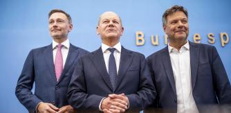 FILE - German Chancellor Olaf Scholz, center, German Minister for Economic Affairs and Climate Protection Robert Habeck, left, and German Minister of Finance Christian Lindner arrive for a press conference on the 2025 budget, in Berlin, on July 5, 2024. (Kay Nietfeld/dpa via AP, File)