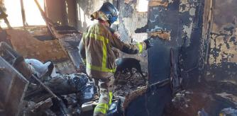 Un bombero inspecciona el interior calcinado de la nave de Badalona