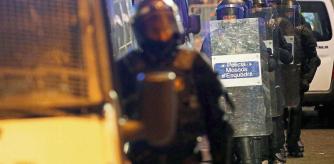 Police officers walk during a protest in support of Catalan rapper Pablo Hasel, after he was given a jail sentence on charges of glorifying terrorism and insulting royalty in his songs, in Barcelona, Spain, February 19, 2021. REUTERS/Albert Gea