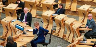 Scotland's First Minister Nicola Sturgeon is seen during a session where she delivered an update on the Covid-19 pandemic to Members of the Scottish Parliament (MSPs) inside the chamber of the Scottish Parliament in Holyrood, Edinburgh on February 16, 2021. - Sturgeon announced to MSPs on Tuesday that some pupils in Scotland will return to schools from February 22, but other lockdown restrictions will remain in place until at least the beginning of March and possibly longer. (Photo by Andrew Milligan / POOL / AFP)