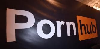 (FILES) In this file photo taken on January 23, 2018 a Pornhub logo is displayed at the company's booth at the 2018 AVN Adult Entertainment Expo at the Hard Rock Hotel & Casino in Las Vegas, Nevada. - Credit card titans Visa and Mastercard on December 10 said they would no longer process payments to Pornhub after US media reported the site hosts videos depicting child sex abuse and rape. (Photo by Ethan Miller / GETTY IMAGES NORTH AMERICA / AFP)