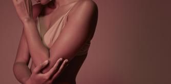 Young woman photographed on studio with coloured lights
