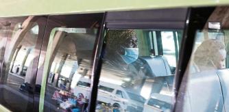 A passenger in a taxi wears a face mask after the announcement of a British ban on flights from South Africa because of the detection of a new coronavirus disease (COVID-19) variant, in Soweto, South Africa, November 26, 2021. REUTERS/Siphiwe Sibeko