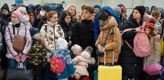 TOPSHOT - People wait for a train to Poland at the railway station of the western Ukrainian city of Lviv on February 26, 2022. - Ukrainian forces repulsed a Russian attack on Kyiv but 