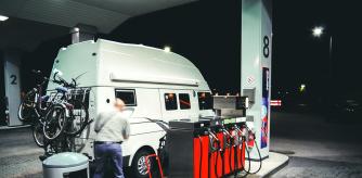 Un vehículo camper realiza un respostaje en una gasolinera para proseguir su viaje