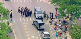 Police deploy after gunfire erupted at a Fourth of July parade route in the wealthy Chicago suburb of Highland Park, Illinois, U.S. July 4, 2022 in a still image from video. ABC affiliate WLS/ABC7 via REUTERS NO RESALES. NO ARCHIVES. MANDATORY CREDIT