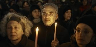 People hold candles as Jewish rabbis and members of the community demand a permanent ceasefire in Gaza during the first night of the Jewish holiday of Hanukkah on Thursday, Dec. 7, 2023, in New York. (AP Photo/Andres Kudacki)