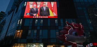 A large screen shows news coverage of Chinese President Xi Jinping (R) meeting German Chancellor Olaf Scholz in Beijing on April 16, 2024. (Photo by Pedro PARDO / AFP)