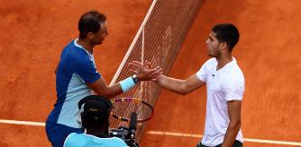 MADRID, SPAIN - MAY 06: Carlos Alcaraz of Spain shakes hands at the net after his three set victory in his quarterfinal match against Rafael Nadal of Spain during day nine of the Mutua Madrid Open at La Caja Magica on May 06, 2022 in Madrid, Spain. (Photo by Clive Brunskill/Getty Images)