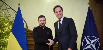 In this handout photograph taken and released by the Ukrainian Presidential Press Service on December 18, 2024, Ukraine's President Volodymyr Zelensky (L) shakes hands with NATO Secretary General Mark Rutte (R) prior to their talks on the sidelines of a EU-Western Balkans summit in Brussels. (Photo by Handout / UKRAINIAN PRESIDENTIAL PRESS SERVICE / AFP) / RESTRICTED TO EDITORIAL USE - MANDATORY CREDIT 