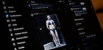 LONDON, ENGLAND - JANUARY 12: In this photo illustration, a screen displays a post by Elon Musk on the X app, showing an AI prompt-created image, made with Xai's Grok app, depicting Musk wearing a bikini, on January 12, 2026 in London, England. Today the UK communications regulator Ofcom launches a formal investigation into Elon Musk's social media platform X regarding its AI chatbot, Grok.ÂThe probe centres on reports that Grok has been used to generate non-consensual sexual deepfakes, including 