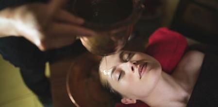 Young woman having an ayurvedic shirodhara treatment
