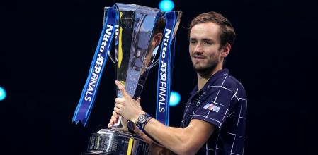 Russia's Daniil Medvedev poses with the winner's trophy after his 4-6, 7-6, 6-4 win over Austria's Dominic Thiem in their men's singles final match on day eight of the ATP World Tour Finals tennis tournament at the O2 Arena in London on November 22, 2020. - Daniil Medvedev came from a set down to beat Dominic Thiem 4-6, 7-6 (7/2), 6-4 and win the ATP Finals title in London on Sunday for the biggest tournament victory of his career. (Photo by Glyn KIRK / AFP)
