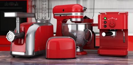Kitchen Appliances Set. Red Blender, Toaster, Coffee Machine, Meat Ginder, Food Mixer and Coffee Grinder on a wooden table. 3d Rendering