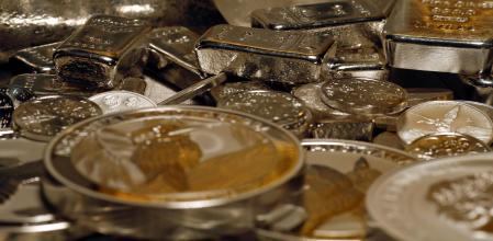 FILE PHOTO: Silver bars and coins are stacked on a table in the safe deposit boxes room of the ProAurum gold house in Munich March 3, 2014. REUTERS/Michael Dalder/File Photo