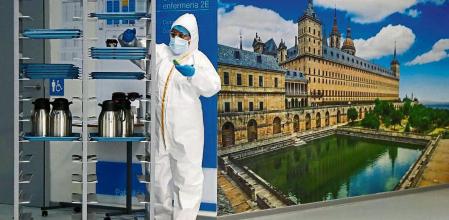 A health staff wearing full individual protection gear works beside a meal cart, as the coronavirus disease (COVID-19) outbreak continues, at Enfermera Isabel Zendal new pandemic hospital in Madrid, Spain, February 4, 2021. REUTERS/Sergio Perez