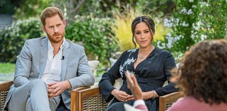 This image provided by Harpo Productions shows Prince Harry, left, and Meghan, Duchess of Sussex, in conversation with Oprah Winfrey. 