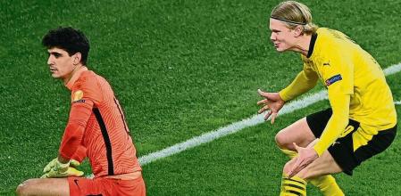 Soccer Football - Champions League - Round of 16 Second Leg - Borussia Dortmund v Sevilla - Signal Iduna Park, Dortmund, Germany - March 9, 2021 Borussia Dortmund's Erling Braut Haaland celebrates scoring their second goal as Sevilla's Bono looks on Pool via REUTERS/Ina Fassbender TPX IMAGES OF THE DAY