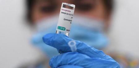 (FILES) In this file photo taken on March 23, 2021 A health worker prepares a dose of the AstraZeneca/Oxford vaccine at a coronavirus vaccination centre at the Fazl Mosque in southwest London, on the first anniversary of the first national Covid-19 lockdown. - AstraZeneca said on April 7, 2021, that two studies conducted by British and European regulators 