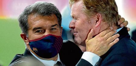 Barcelona's Dutch coach Ronald Koeman (R) celebrates with club president Joan Laporta at the end of the Spanish Copa del Rey (King's Cup) final football match between Athletic Club Bilbao and FC Barcelona at La Cartuja stadium in Seville on April 17, 2021. (Photo by CRISTINA QUICLER / AFP)