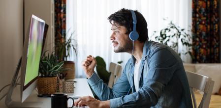 Young men playing video games with desktop