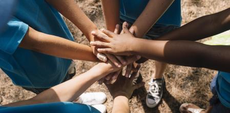Group of kids stacking hands