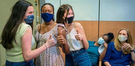 Lilly Gorman, 15, left, Croix Hill, 15 and Ava Kreutziger, 14, give a thumbs up after the Isidore Newman School students received their first dose of the COVID-19 vaccine at the Ochsner Center for Primary Care and Wellness, after the Centers for Disease Control and Prevention recommended the Pfizer vaccine for use in teenagers ages 12 to 15 in New Orleans, Louisiana, U.S., May 13, 2021. REUTERS/Kathleen Flynn