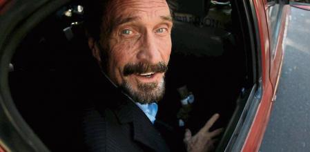 FILE PHOTO: Software pioneer John McAfee is escorted by immigration officers to the Guatemalan Airport in Guatemala City December 12, 2012. REUTERS/Jorge Dan Lopez/File Photo