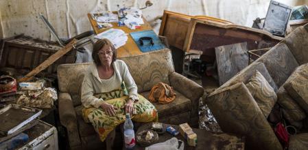 CORRECTED VERSION: BAD NEUENAHR, GERMANY - JULY 17:  Jutta Schelleckes (72) sits in the living room of her apartment, which was completely destroyed by the flood on July 17, 2021 in Bad Neuenahr, Germany. The furniture has been overturned. Electricity and water do not work. She has been living in the mess for 2 days. Her husband sits in the bedroom with the dog with an injured foot. A neighbor helps shovel out mud.  Firefighters will later escort her out of her apartment and find shelter. While the water masses are slowly receding from many flooded areas in North Rhine-Westphalia and Rhineland-Palatinate, the search for fatalities continues in the rubble of the disaster areas. By Saturday, that number had risen to more than 130, with more than 90 people killed in the greater Ahrweiler area alone, according to police. (Photo by Thomas Lohnes/Getty Images)