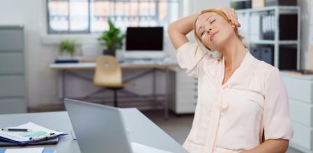 Tired young businesswoman taking a break and a moment to relax with her eyes closed and head tilted to the side
