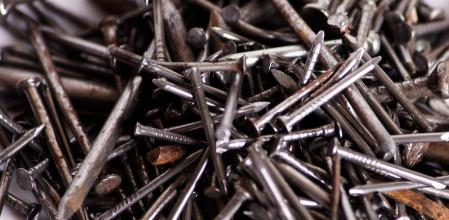 Bunch of different metal nails on white background