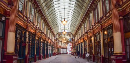 London, United Kingdom - February 21 2021: people walk past closed shops in Leadenhall Market during the coronavirus lockdown.
