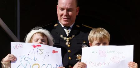 Prince Albert II of Monaco, Prince Jacques and Princess Gabriella holding message which read 