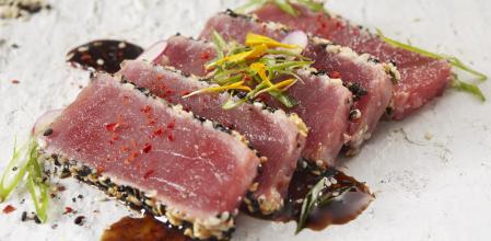 Ahi Tuna Tataki with a Soy Vinaigrette , Green Onions, Korean Chili Powder and Edible Flowers