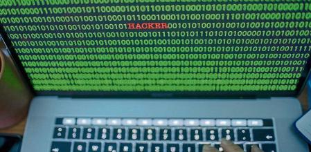 04 January 2019, Mecklenburg-Western Pomerania, Schwerin: ILLUSTRATION - Between the binary code on a laptop monitor you can see the text 