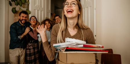 Shot of a smiling young businesswoman being excluded from her colleagues in a office