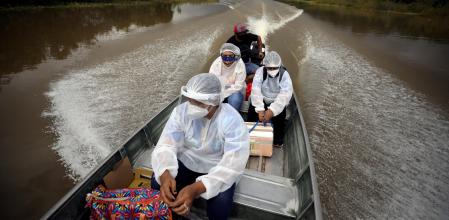 Municipal health workers travel on a boat along the Solimoes river banks, where Ribeirinhos (river dwellers) live, to administer the AstraZeneca/Oxford vaccine for the coronavirus disease (COVID-19) to the residents, in Manacapuru, Amazonas state, Brazil, February 1, 2021. Picture taken February 1, 2021. REUTERS/Bruno Kelly TPX IMAGES OF THE DAY - RC24LL9N5T2J