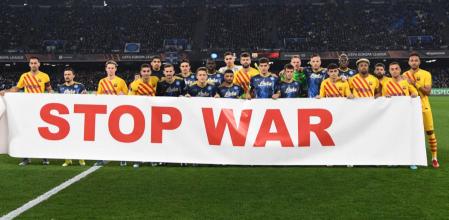 Los jugadores de Barça y Nápoles con una pancarta contra la guerra