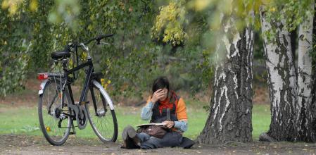 A woman sitting under a birch tree writes in a book on September 24, 2008 at the Tiergarten park in Berlin. Autumn brought a sunny day with temperatures up to 17 degrees Celsius to the German capital. AFP PHOTO DDP/THEO HEIMANN GERMANY OUT (Photo credit should read THEO HEIMANN/DDP/AFP via Getty Images)