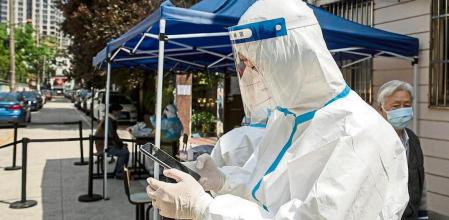 A worker in personal protective equipment (PPE) facilitates a round of Covid-19 testing during a lockdown in Shanghai, China, on Saturday, April 16, 2022. Shanghai is the epicenter of an outbreak of the highly contagious omicron variant in China, straining the government#{emoji}146;s ability to enforce PresidentXi Jinping's demand that cities be totally free of the virus, a strategy known as Covid Zero. Phootgrapher: Qilai Shen/Bloomberg