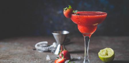 Ice Strawberry alcohol cocktail with lime and rum in a glass