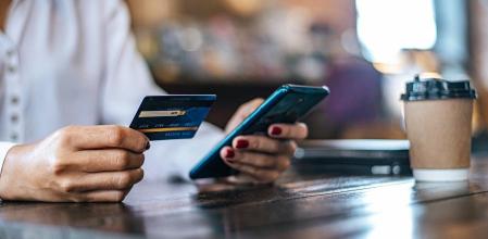 Mujer realizando compra con su tarjeta de crédito
