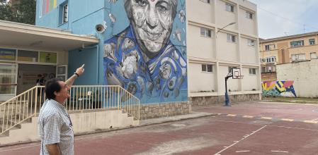 Vicent Ripoll señala la localización de las futuras placas solares. En el centro luce un mural Dones de Ciència, en homenaje a Vandana Shiva