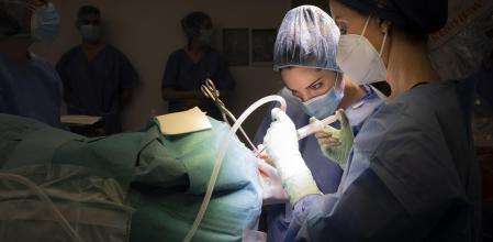 Primera Intervención robótica para una cefalea de racimo en Hospital del Mar. perforación craneal para introducir el dispositivo . Quirófano, operación robotizada, cirujanas, mujeres sanitarias.