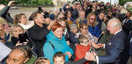LONDON, UNITED KINGDOM - SEPTEMBER 17: King Charles III meets members of the public in the queue along the South Bank, near to Lambeth Bridge, as they wait to view Queen Elizabeth II lying in state ahead of her funeral on Monday, on September 17, 2022 in London, United Kingdom. Queen Elizabeth II is lying in state at Westminster Hall until the morning of her funeral to allow members of the public to pay their last respects. Elizabeth Alexandra Mary Windsor was born in Bruton Street, Mayfair, London on 21 April 1926. She married Prince Philip in 1947 and acceded to the throne of the United Kingdom and Commonwealth on 6 February 1952 after the death of her Father, King George VI. Queen Elizabeth II died at Balmoral Castle in Scotland on September 8, 2022, and is succeeded by her eldest son, King Charles III. (Photo by Aaron Chown-WPA Pool/Getty Images)