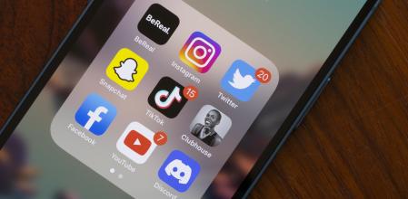 Portland, OR, USA - Aug 23, 2022: Assorted popular social media apps - BeReal, Instagram, Twitter, Snapchat, TikTok, Clubhouse, Facebook, YouTube, and Discord - are seen on an iPhone. BeReal is a French social media app rising in popularity, and can be anti-social in some ways. Users receive a notification at a random time once a day saying 'Time to BeReal'. This opens up a two-minute window for the user to post a picture of what they are currently doing. The purpose of this is to capture an authentic, unfiltered snapshot of a user's life.