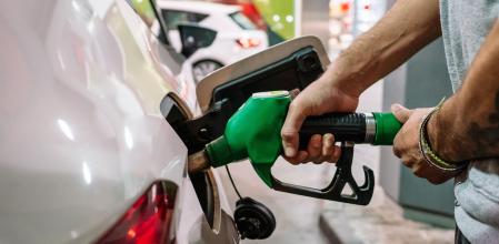 Un hombre echa gasolina a su coche