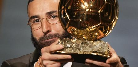 Real Madrid's Karim Benzema celebrates after winning the 2022 Ballon d'Or trophy during the 66th Ballon d'Or ceremony at Theatre du Chatelet in Paris, France, Monday, Oct. 17, 2022. (AP Photo/Francois Mori)