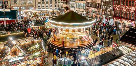 Lights illuminate the traditional Christmas Market with a merry-go-round, in Frankfurt, Germany, Monday, Nov. 21, 2022. (AP Photo/Michael Probst)