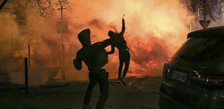 Protesters throws projectiles during clashes with police following a rally in support to Corsican nationalist figure Yvan Colonna a week after he was attacked in prison, in Bastia, Corsica, on March 13, 2022. - Colonna, who is serving a life sentence for the assassination in 1998 of Corsica's top regional official Claude Erignac, is in a coma after being beaten on March 2 in the jail in Arles by a fellow detainee, according to investigators. Colonna was jailed in the south of France with authorities long rejecting his demand to be transferred to Corsica, saying his offence made him a special status detainee. (Photo by Pascal POCHARD-CASABIANCA / AFP)